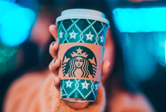 Woman holding Starbucks cup