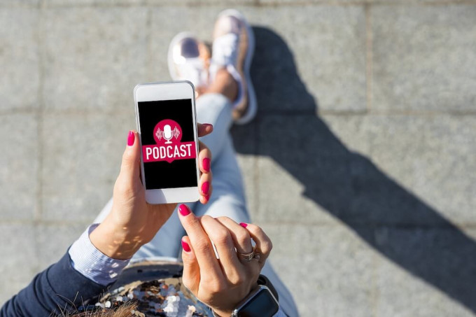 Young woman listening to podcast on smartphone