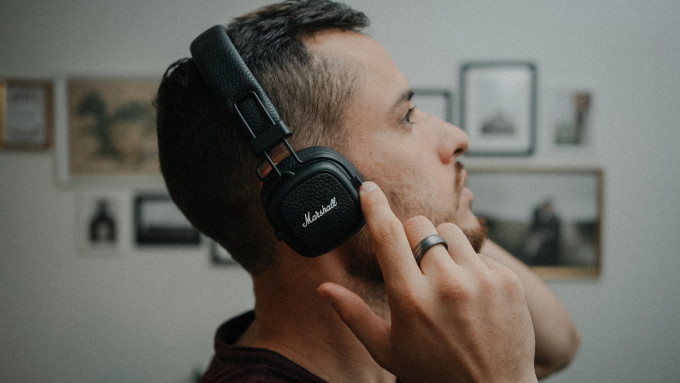man listening with marshall headphones