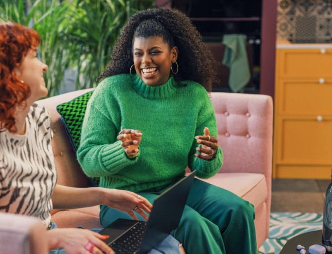 Two women coworkers engaging in friendly conversation