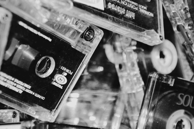 black and white cassette tapes up close header image for how to edit a podcast