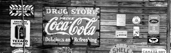 Wooden backdrop with old school Coca Cola sign on it
