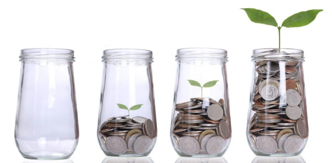 Glass jars filled with coins and a small plant