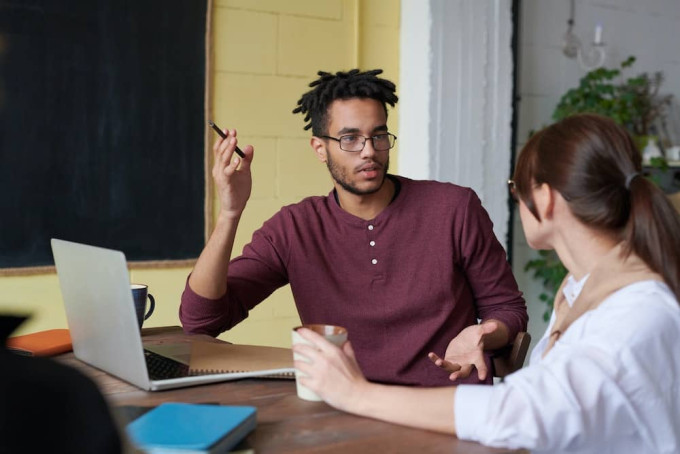 Man and woman having a conversation - Part of knowing how to be a good podcast host is knowing how to listen