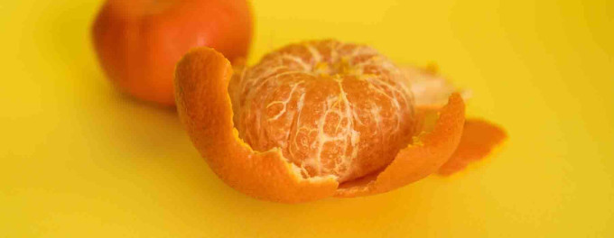 Bright orange peeled satsuma with peel