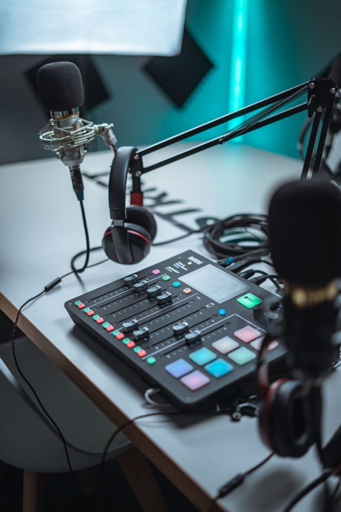 Podcast setup with mic, headphones and mixing board
