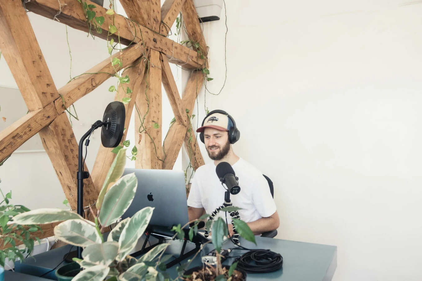 Man recording a podcast episode in front of a plain white background