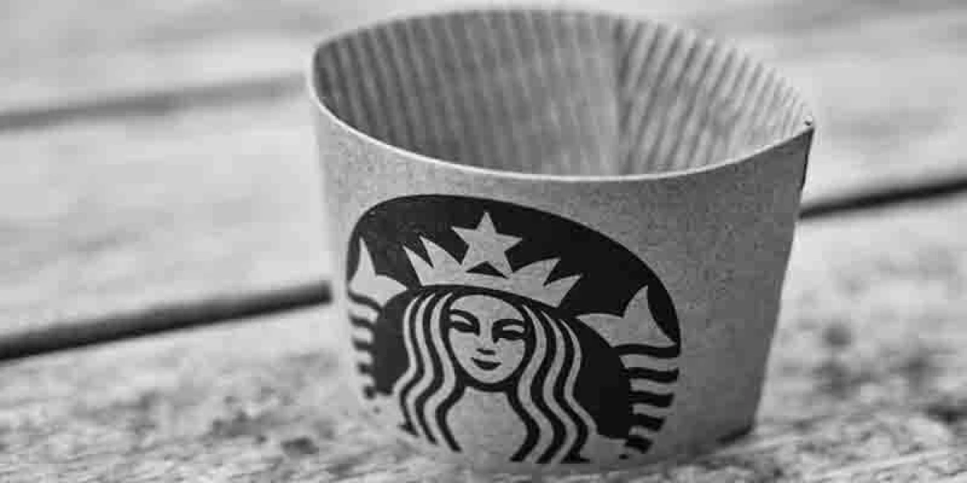 black and white image of a starbucks cup sleeve to header the digital marketing podcast blog