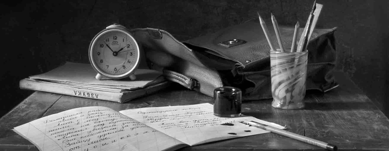 a desk with wriiting pens and a journal to show the idea of preparing a narrative podcast script