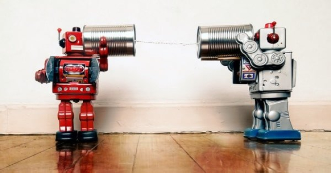Robots communicating with cans connected by a string to show how an internal company podcast can help employee communication